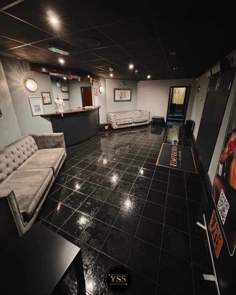 Shiny black tiled floor after professional cleaning by Your Sparkling Services Ltd.