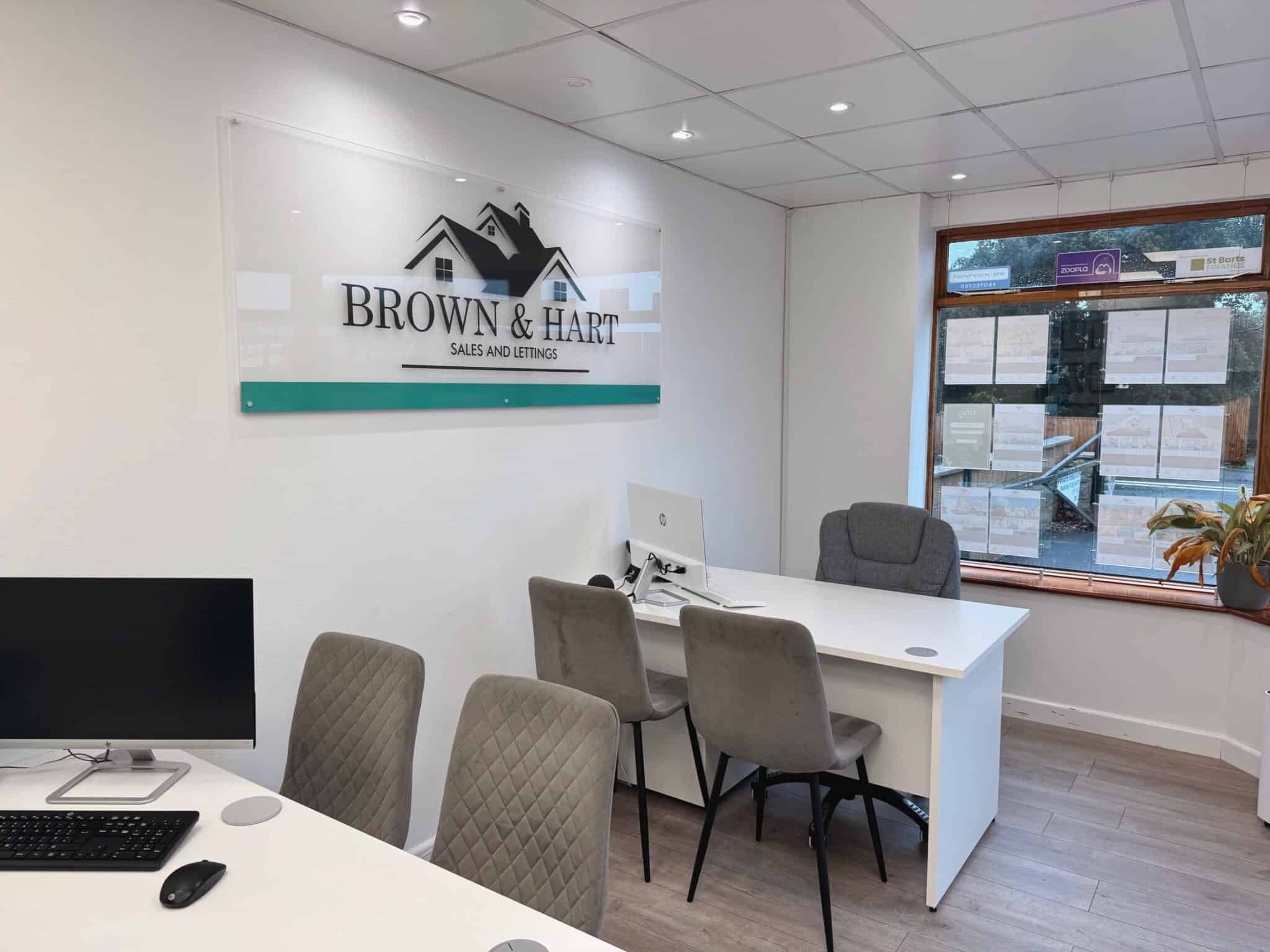 Modern real estate office interior with Brown & Hart signage, sales and lettings, bright lighting, and comfortable seating - Your Sparkling Services Ltd.